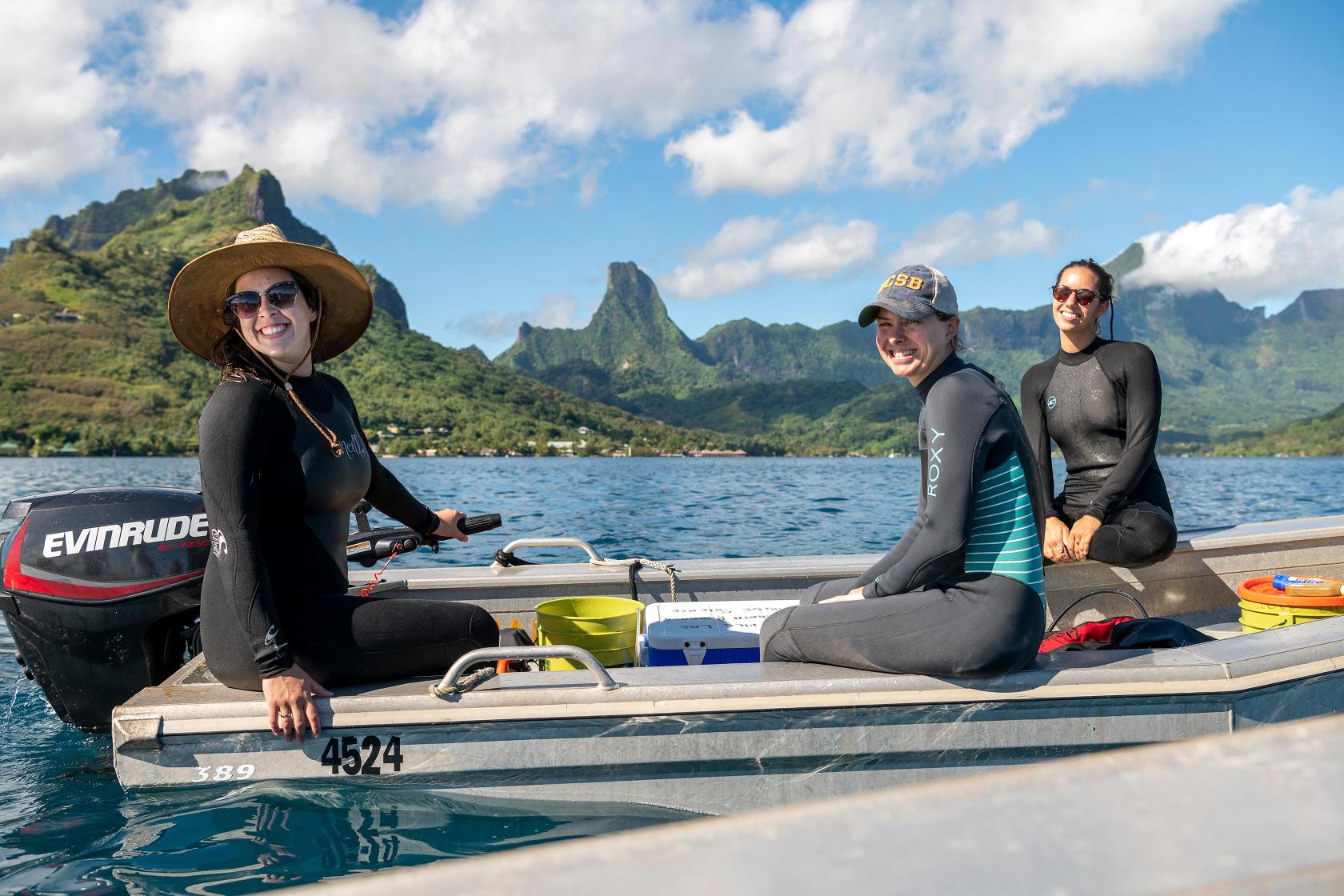 Two student researchers on motorboat in Moorea